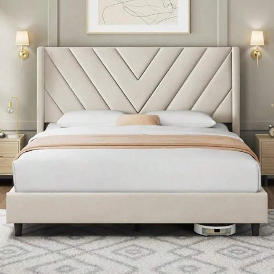 Beige upholstered queen bed frame shown in a styled bedroom; bedding and decorative accessories are not included